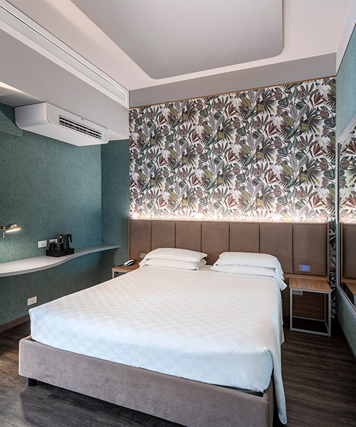 Deluxe Room with double bed, decorative wall and desk corner